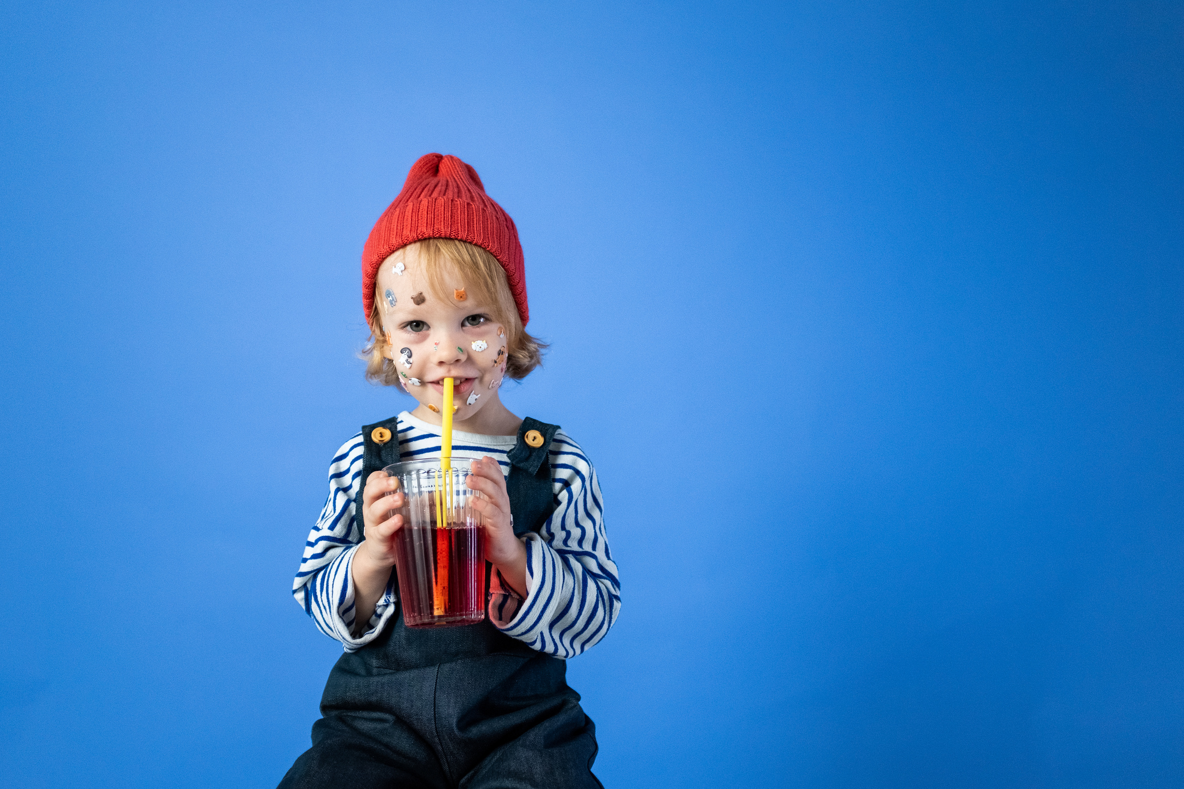 Girl in Red Knit Cap and Striped Long Sleeve Shirt